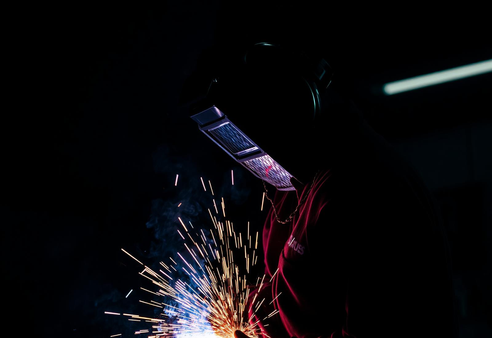 Welder at work with sparks flying
